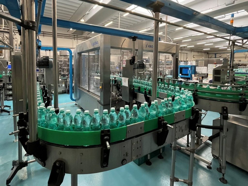 Krones 2013 bottle labeler for PET bottles up to 25,000 BPH, with OPP hot-glue labels and Siemens PLC. Available as-is or refurbished.
