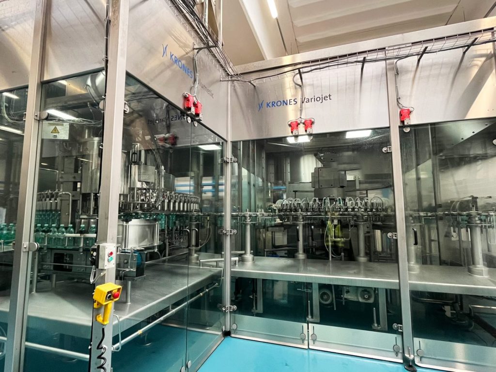 Riempitrice Krones Variojet per bottiglie PET fino a 25.000 bph, con tappatrice Zalkin, PLC Siemens e HMI Krones. Disponibile usata o revisionata.