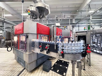 Sacmi VOLOMAS bottle filler for plastic or PET bottles, 40,000 bph. Complete with Premix, CIP, Arol capper, and air conveyors. Ideal for water and soft drinks.