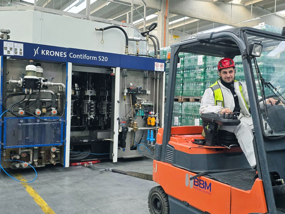 BBM technician moves KRONES blow molding machine with BBM-owned vehicle